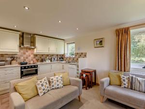 a living room with two couches and a kitchen at 3 Bed in Newlands Valley SZ508 in Braithwaite