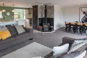 a living room with a couch and a fire place at Pip's Lakeview Retreat in Wanaka