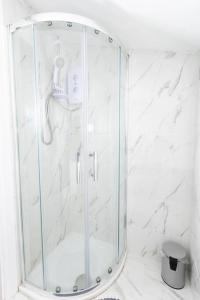 a shower with a glass door in a bathroom at Modern and Luxury House for 8 in Gillingham