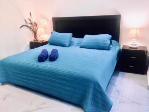 sypialnia z łóżkiem z niebieską pościelą i niebieskimi poduszkami w obiekcie Casa Ohana By Utopia w mieście Playa del Carmen