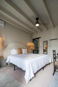 a bedroom with a large white bed in a room at HOLT Hotel del Pueblito in San Miguel de Allende