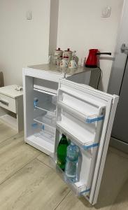 an open refrigerator with two bottles of water in it at Yugoslavija 2 centar in Aleksandrovac