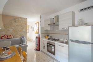 a kitchen with a white refrigerator and a table at La Casita in Brendola