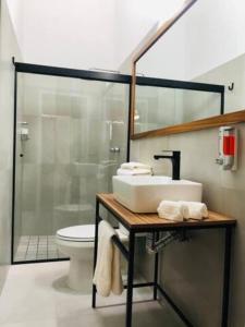 a bathroom with a sink and a toilet at Urban Chapalita in Guadalajara