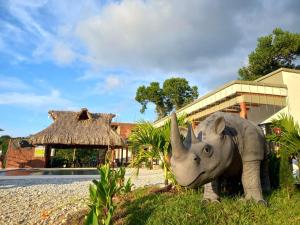 a statue of an elephant in front of a building at finca campestre las heliconias in Puerto Triunfo