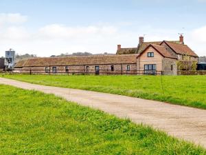 an old house on a grass field next to a dirt road at 2 bed in Bath 72836 in Chew Magna