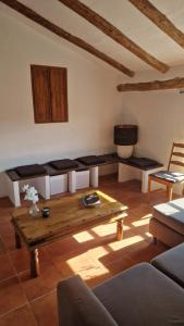 a living room with a table and a couch at Casa De La Familia - Casa Rural in Baza