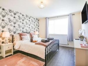 a bedroom with a bed and a large window at 3 bed in Conwy 87866 in Penmaen-mawr
