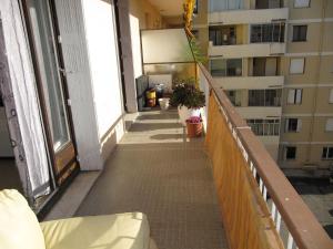 a balcony of a building with potted plants on it at Appartement à 50 mètres de la plage in Cagnes-sur-Mer