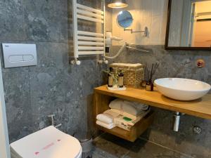 a bathroom with a sink and a toilet at Deluxe Apartment at the seaside in Pasaport Alsancak Izmir in Konak