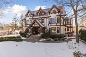 a large house with snow on the ground at Luxury 6600 sq.ft Stunning Home/Sleeps 10+ in Minneapolis