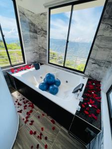 a bathroom with a bath tub with red roses on the floor at Esmeralda DELUXE in San Gil