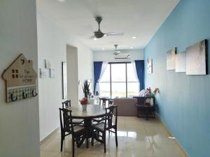 a dining room and living room with a table and chairs at PuchongIsland WindyStay3R2B8Pax AT D'Island in Puchong