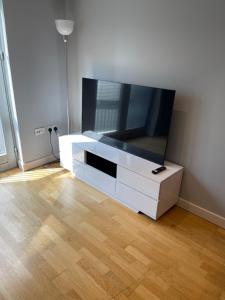 a white entertainment center with a flat screen tv at 2 Bedroom Flat in Bedford