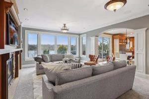 a living room with a couch and a table at Luxury 7400 sq.ft Stunning Home Theater/Sleeps 18+ in Plymouth