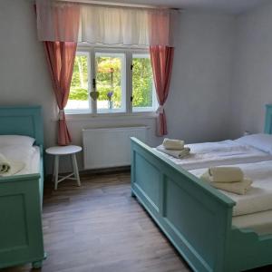 a bedroom with a large bed and a window at CHalupa Relax in Dolní Lomná