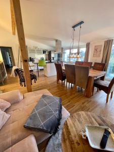 a living room and dining room with a table and chairs at Eifelsuiten - Suiten mit Sauna, Kamin und Balkon in der Vulkaneifel - Kerpen Loogh in Kerpen