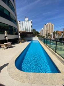 a swimming pool in the middle of a building at Quarto c/Ar, sala, cozinha, banheiro, garagem 24h. in Salvador
