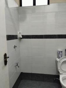 a bathroom with a toilet and a sink at Cosy Studio Apartment in Nakuru.Lift.Wifi.Ample Parking in Nakuru