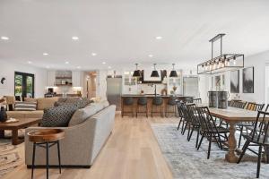a living room and kitchen with a couch and a table at Luxury Cowdry Cottage Lake Home in Alexandria