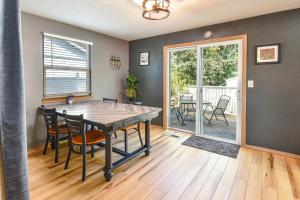 a dining room with a table and chairs and a patio at Teak- a North Albany family home in Albany