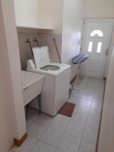 a small bathroom with a toilet and a sink at Eden Place Apartments in Saint Johnʼs