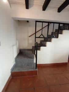 a staircase in a room with a white wall at Depto Tobas in Ushuaia