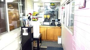 a coffee shop with a counter and a window at American inn in Elko