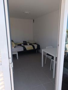 a small bedroom with a bed and a table at Camping Invernaderito in Tejina