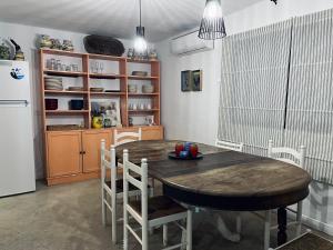 a kitchen with a table and chairs and a refrigerator at LA GORDA in Castilblanco de los Arroyos