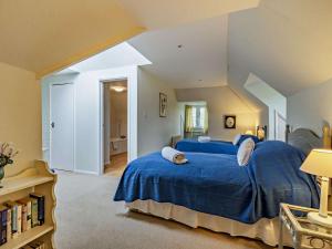a bedroom with a blue bed in a attic at 4 Bed in Uckfield BT021 in Buxted