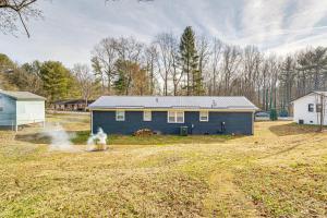 a blue house in the middle of a field at Pet-Friendly Morganton Home with Large Backyard! in Morganton