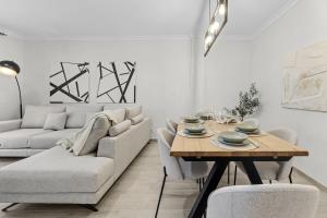 a living room with a table and a couch at Casahost Guenia Beach Apartment in Arrecife
