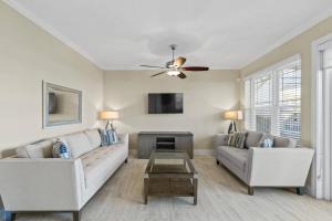 a living room with two couches and a tv at Sunset Inlet Luxury Oasis Flagler Beach in Flagler Beach +42 photos