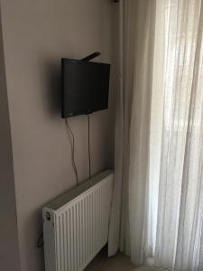 a flat screen tv on a wall next to a window at Safranbolu student hostel woman only in Karabük