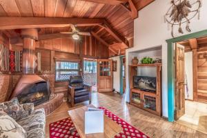 a living room with a couch and a fireplace at Deer Meadows: Adorable, Centrally Located Ruidoso Cabin with Private Hot Tub! in Ruidoso