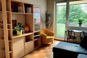 a living room with a book shelf and a table at Quiet and cozy 15 min bus to city center in Iru