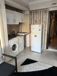 a kitchen with a refrigerator and a washing machine at Safranbolu student hostel woman only in Karabük