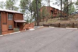 an empty parking lot in front of a house at Grisham's View Condo: Central Condo with a Golf Course View! in Ruidoso