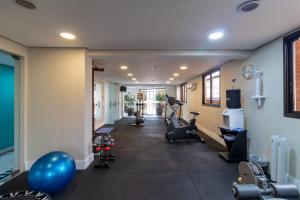a gym with treadmills and exercise equipment in the hallway at LFlats no Hotel Hampton Park Jardim Paulista in São Paulo