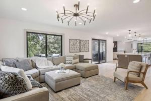 a living room with a couch and chairs and a chandelier at Luxury Hastings Home, Sleeps 18+ in Hastings