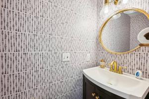 a bathroom with a sink and a mirror at Federal Hill Luxury + City Charm in Baltimore +15 photos