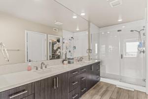 a bathroom with two sinks and a shower at Oceanside Escape in Oceanside +30 photos