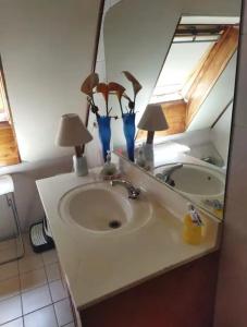 lavabo con 2 lámparas y espejo en Habitación para dos personas cama matrimonial y Habitación para una persona cama individual en Valdivia