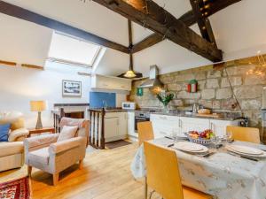 a kitchen and living room with a table and chairs at 2 bed in Brailsford PK816 in Brailsford