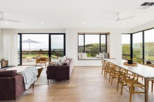 a living room with a couch and a table at Topdeck at Snelling Beach in Stokes Bay