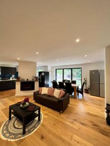 a living room with a couch and a table at En-suites and Rooms Near Wembley Stadium in London