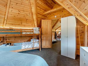 a bedroom with two bunk beds in a wooden house at 1 Bed in Biggar 91248 in Libberton