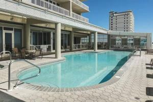 a large swimming pool on top of a building at 4 Bedroom Luxury High Rise Corner Condo with 2 Balconies, Heated Pool, Direct Beach Access in Gulf Shores