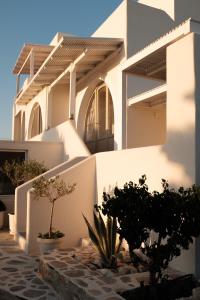 una casa bianca con delle piante davanti di Villa Faros a Spiaggia di Aliko